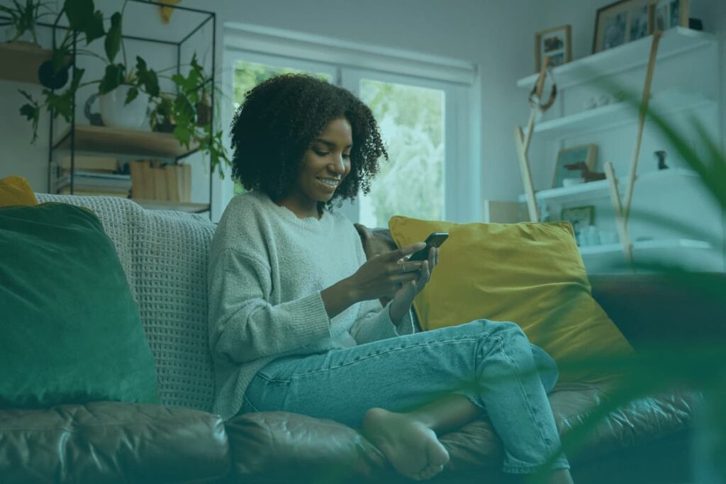 female teacher using phone at home